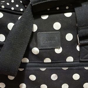 Pink duffle and suitcase